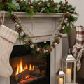 Crystal and pine cone garland on natural twine draped over fireplace mantel with holiday greenery
