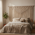 Large bohemian macrame headboard mounted on bedroom wall with neutral linen bedding