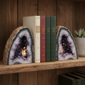 Split geode crystal bookends with sparkling agate interior on wooden shelf